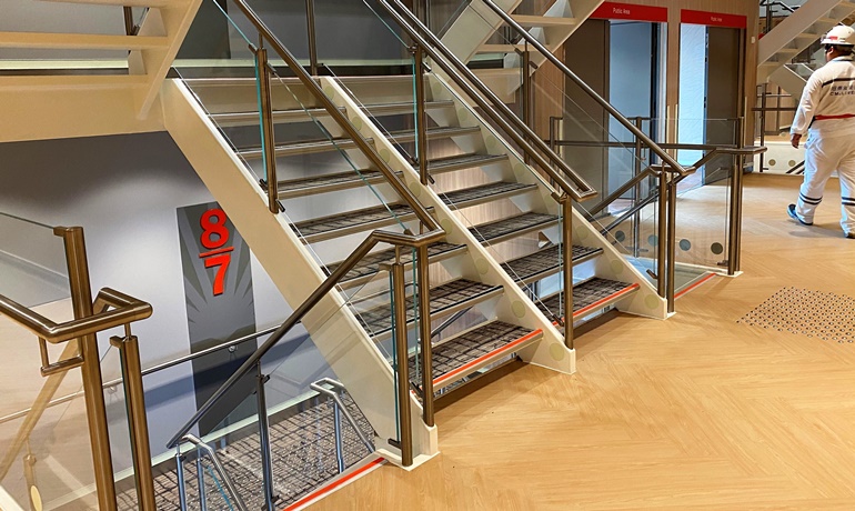 The main stairway that separates the public spaces from the cabin accommodation aft. © CMI Jinling Weihai Shipyard The main stairway that separates the public spaces from the cabin accommodation aft. © CMI Jinling Weihai Shipyard