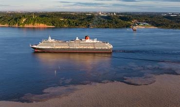 Cunard's QUEEN VICTORIA starts major refit next week. Here she is seen sailing through the “Meeting of Waters” where the dark waters of Rio Negro and the pale Amazon river in Manaus, Brazil, meet.  © Cunard
